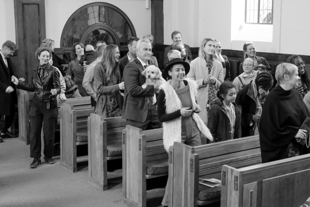a black and white photo of people in a church