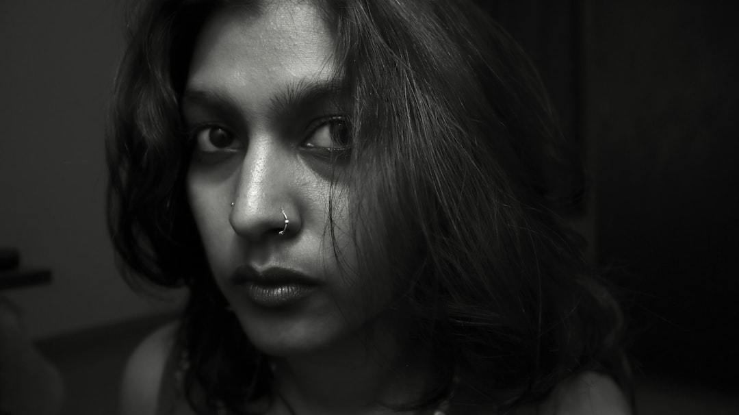 A black and white portrait of a young woman.