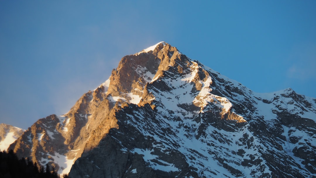 a snow covered mountain with a blue sky in the background
